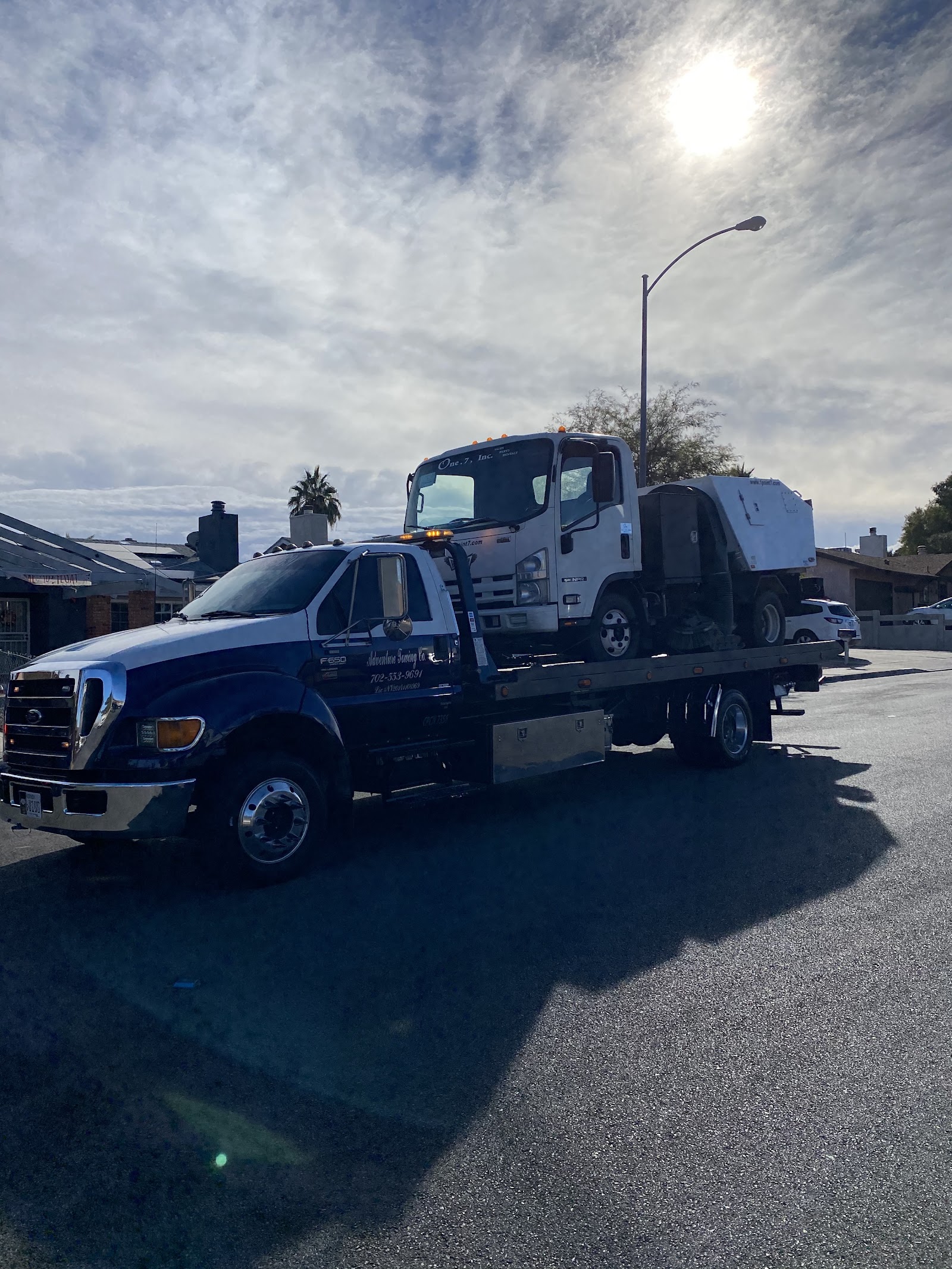 Adventure Towing Co. flatbed carrying a box truck